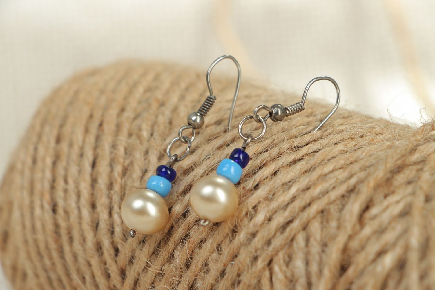 Metal earrings with pearl-like beads photo 4