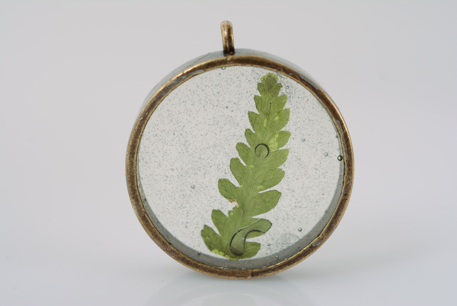 Small round transparent pendant with natural green leaf in epoxy resin on chain photo 2