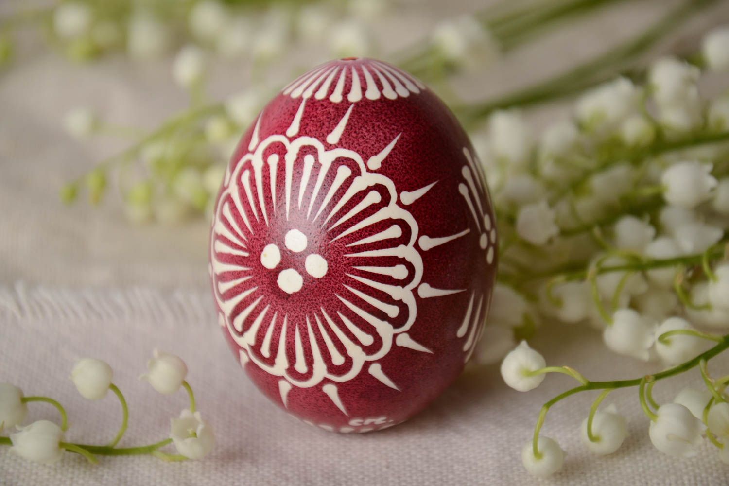 Red and white handmade designer painted Easter egg ornamented using waxing technique photo 1