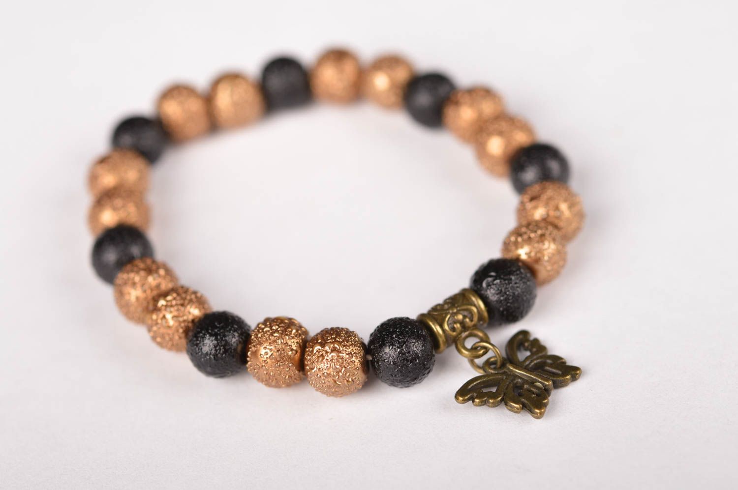 Elastic handmade black and gold color beads bracelet with butterfly charm photo 2