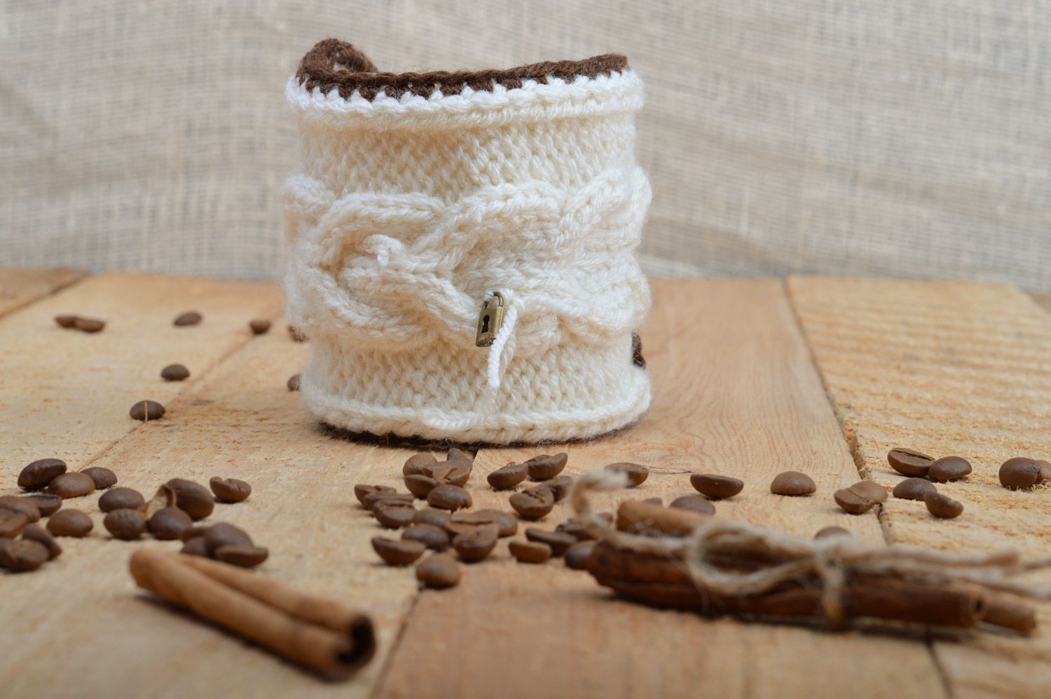 Cute handmade cup cozy knitted of white woolen threads with tiny metal lock photo 1