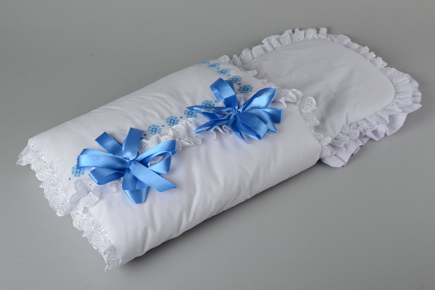 Handmade newborn blanket sewn of cotton with embroidery and blue ribbons photo 1