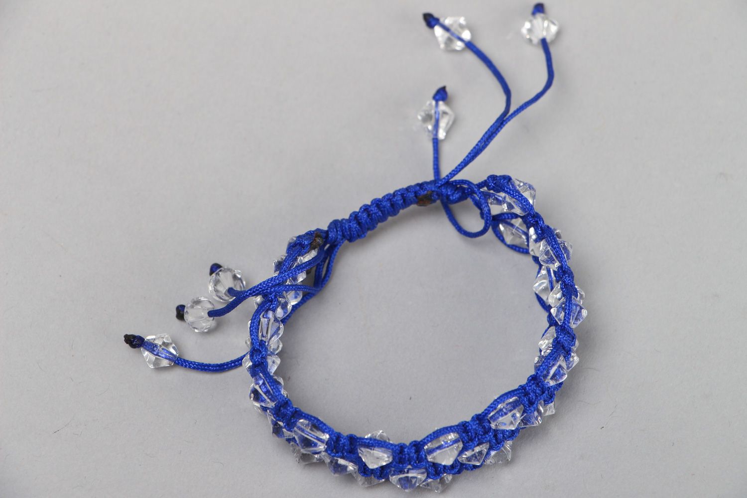 Handmade blue friendship bracelet with synthetic thread and faceted glass beads photo 2