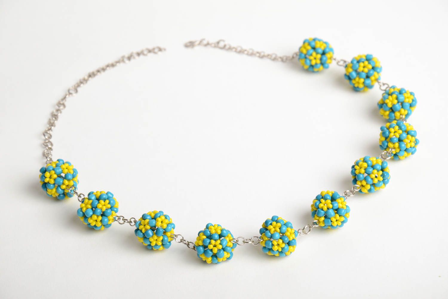 Handmade designer necklace with metal chain and bead woven blue and yellow balls photo 3
