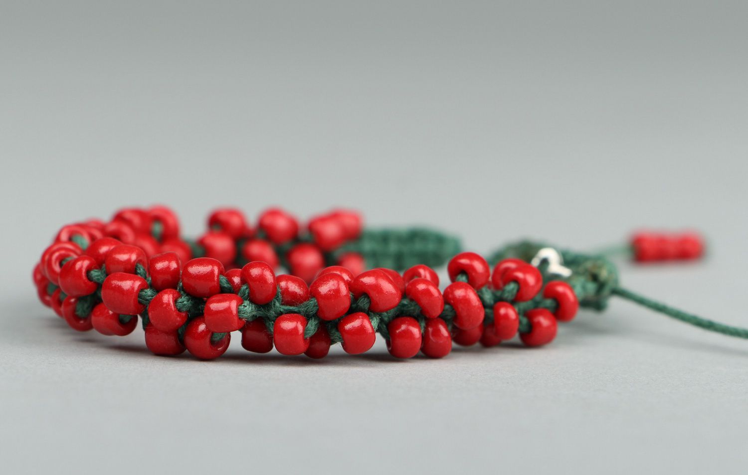 Red bracelet with beads photo 2