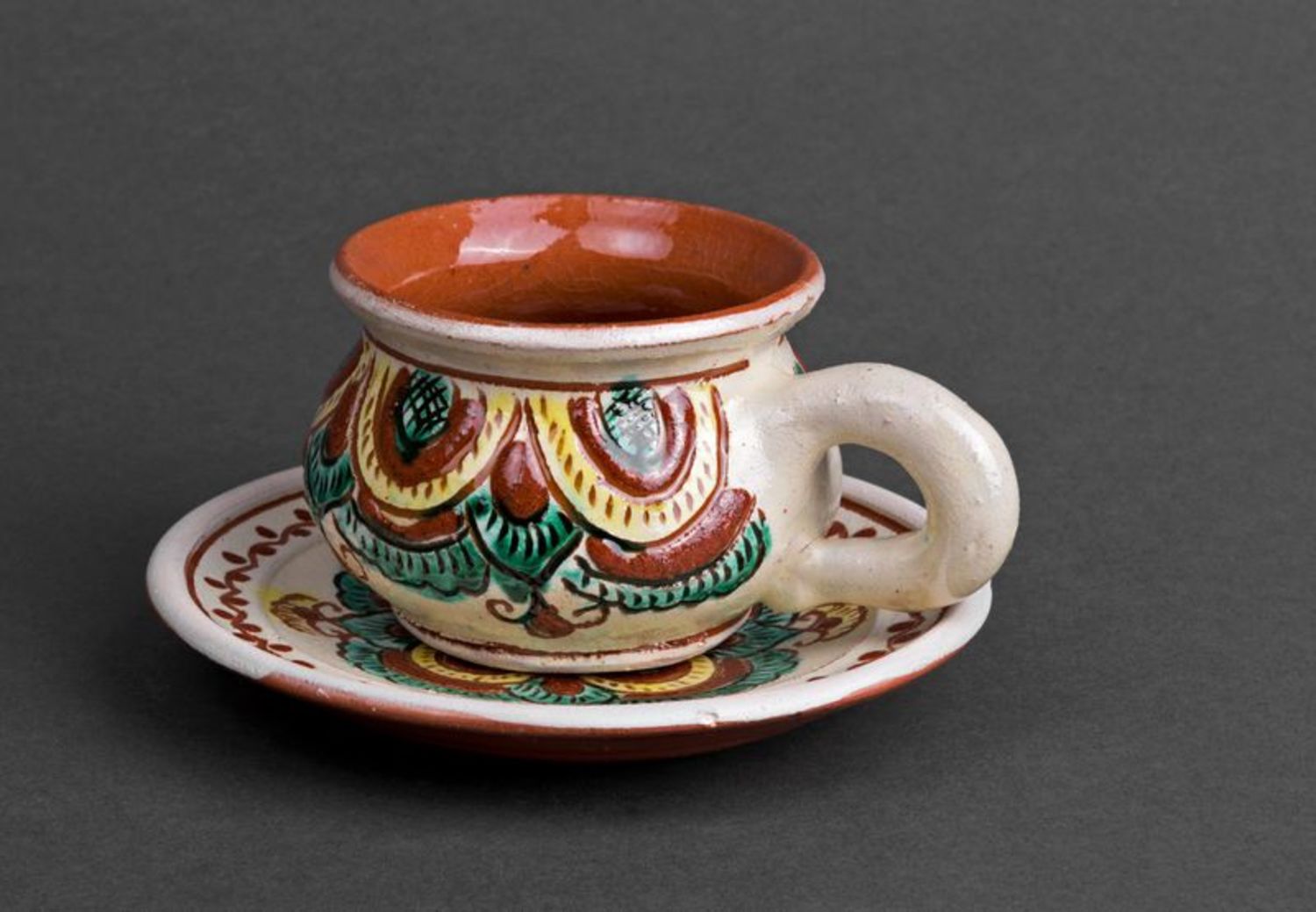 Rustic style clay coffee cup with handle and saucer with Ukrainian style brown and green color pattern photo 5