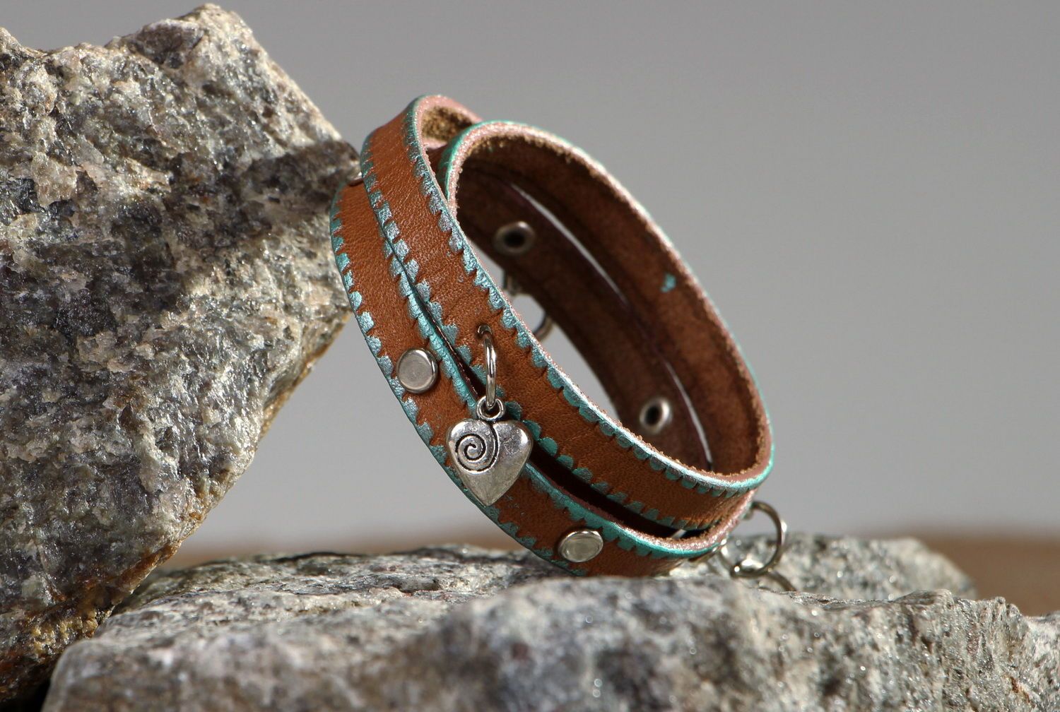 Leather bracelet on the hand with rivets photo 1