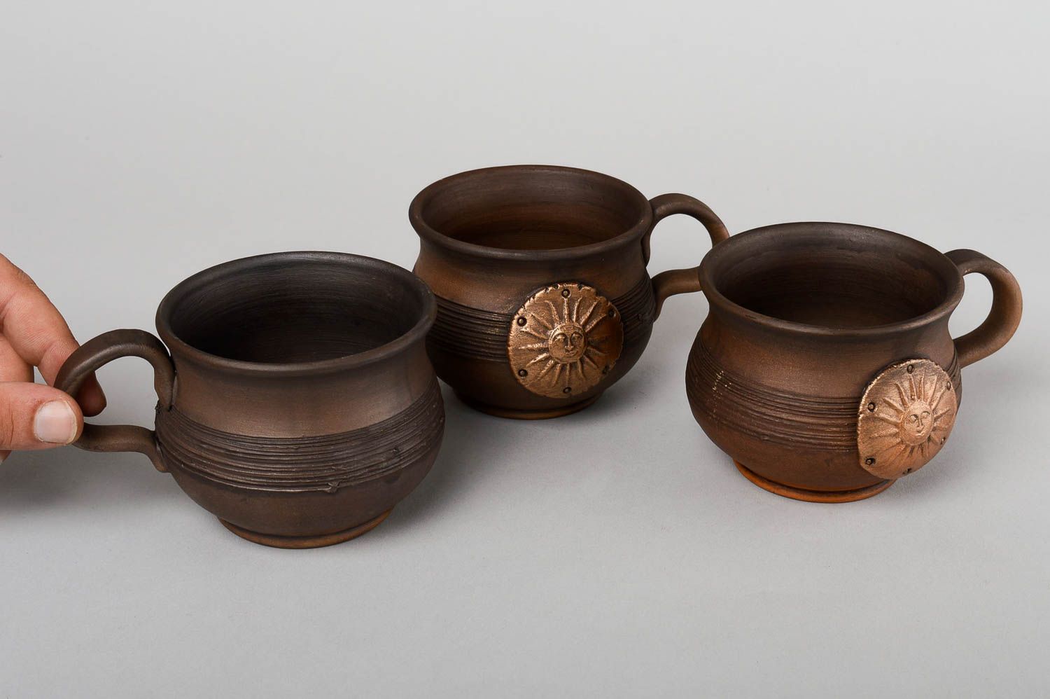 Set of 3 three clay coffee cups in dark brown color with molded sun pattern photo 5