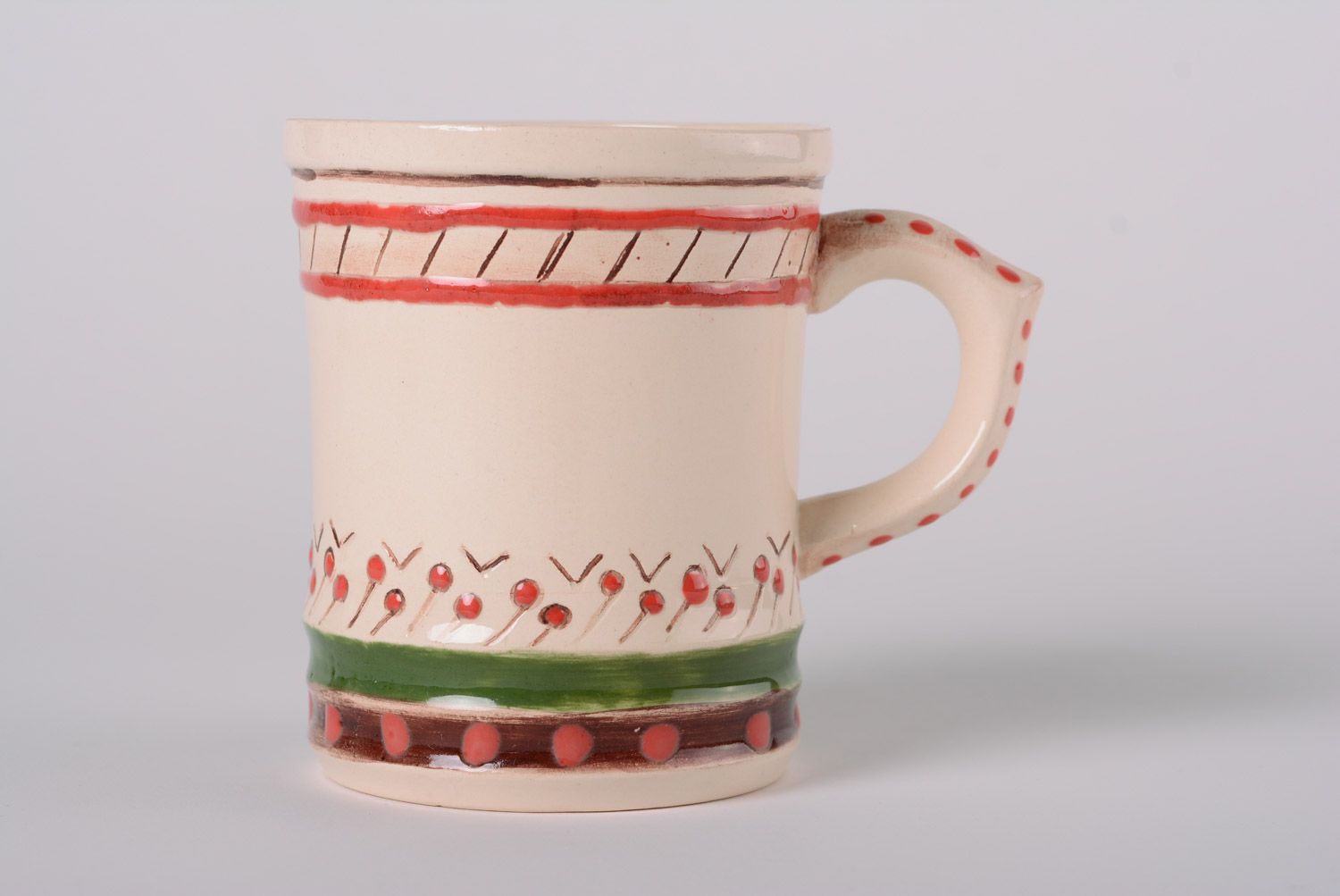 Glazed maiolica ceramic cup painted with red and green dots in the Ukrainian style photo 1