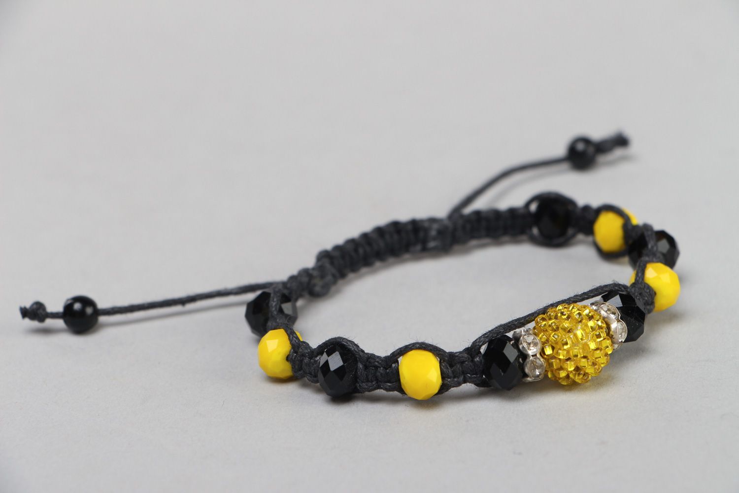 Handmade friendship bracelet woven of black cord and yellow beads for women photo 1