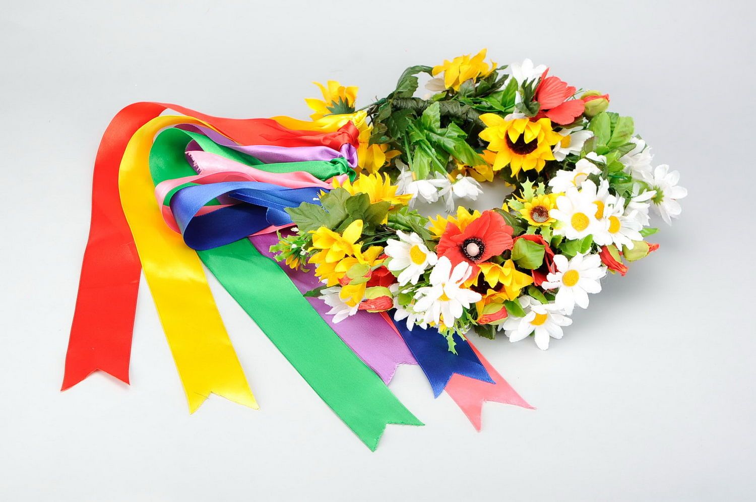 Wreath with decorative flowers and satin ribbons photo 1