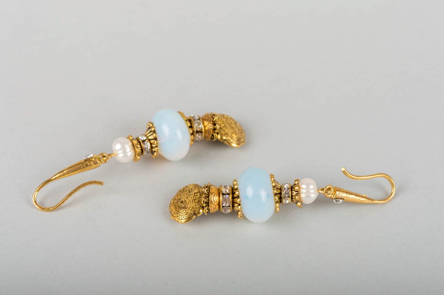 Beautiful female earrings with charms made of metal with pearls and moonstone photo 5