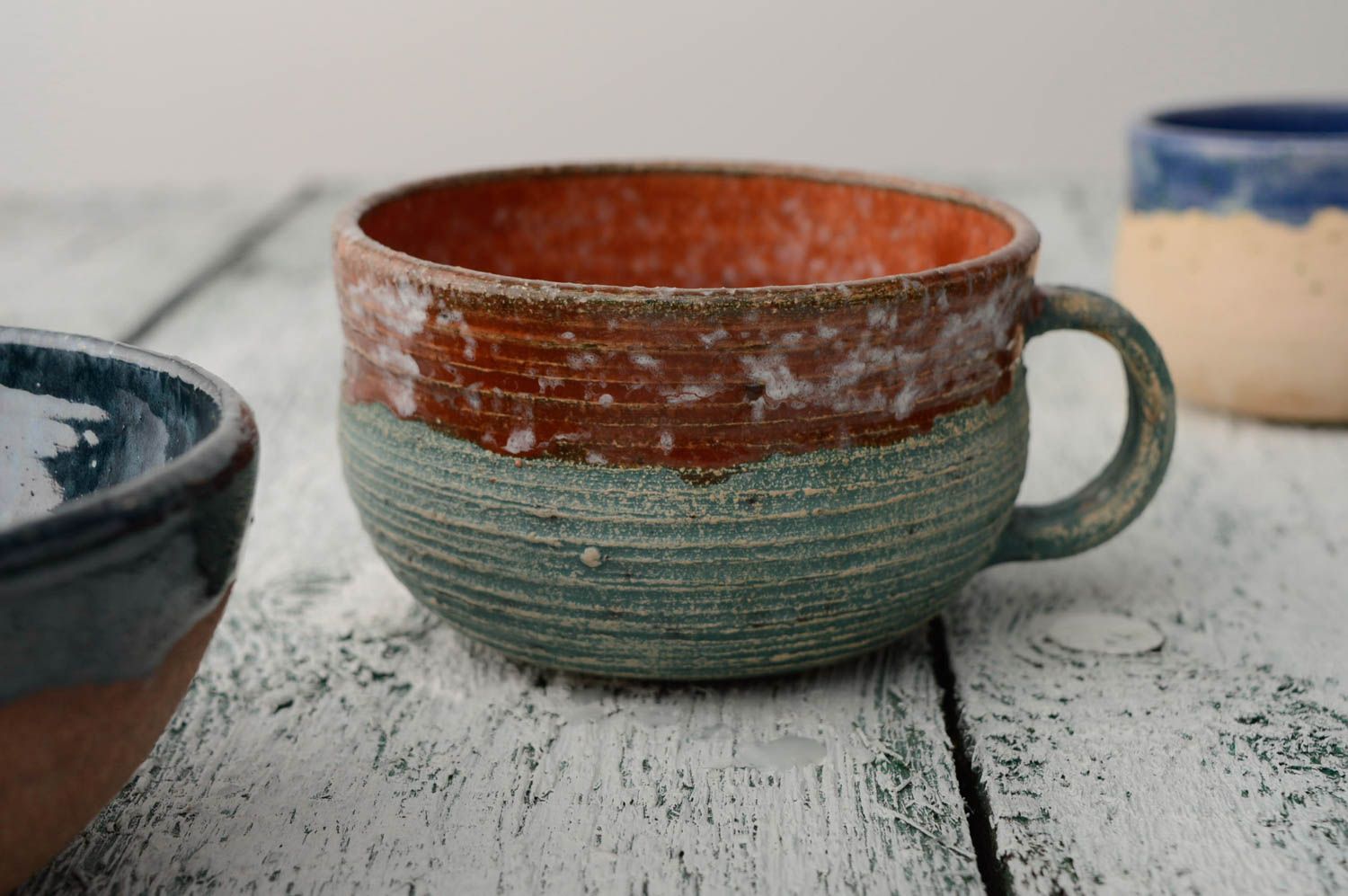 8 oz wide glazed handmade ceramic cup in blue and brown color with handle and no pattern photo 1