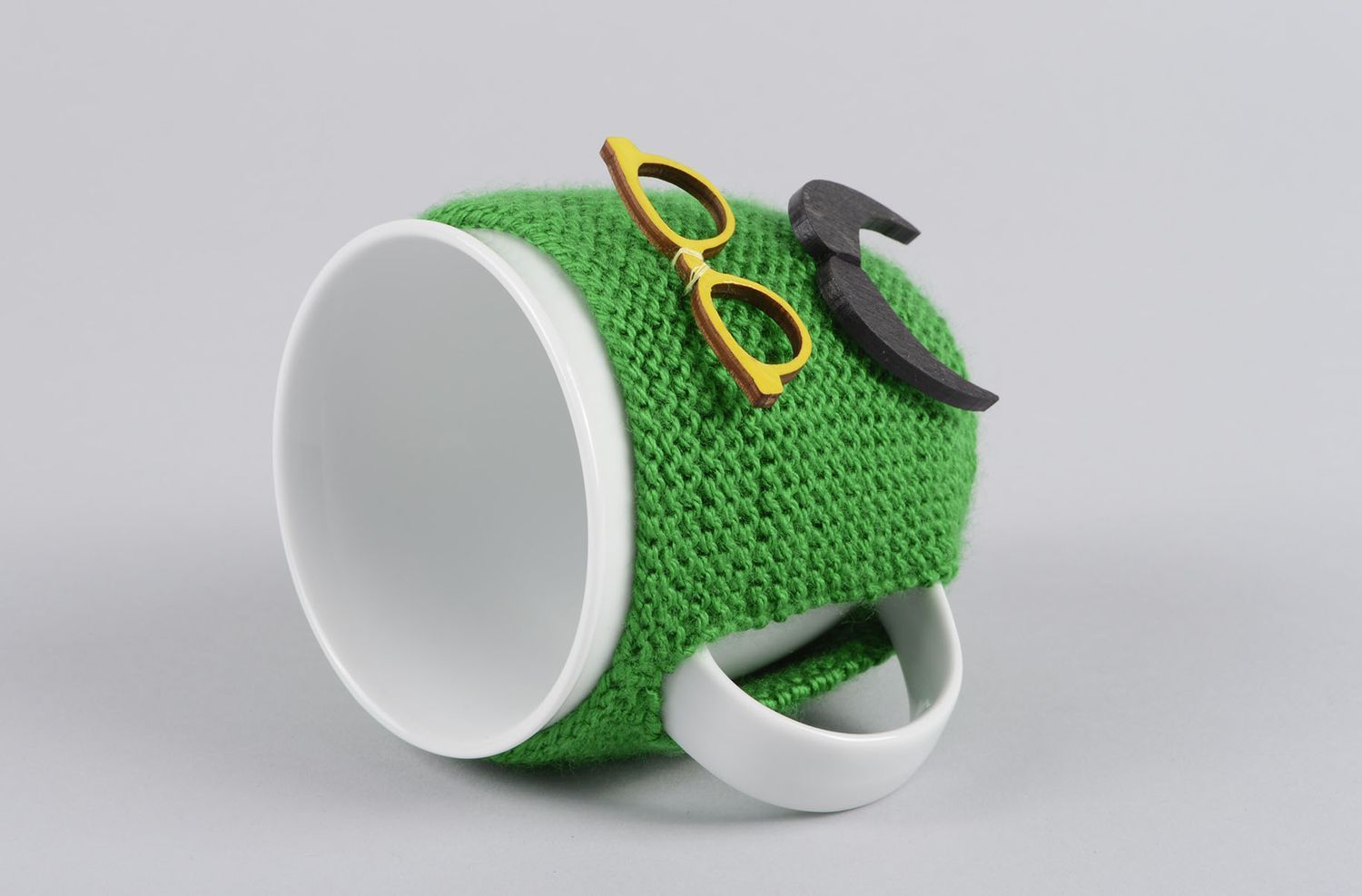 White ceramic porcelain teacup with handle and green man with mustache knitted cover photo 2