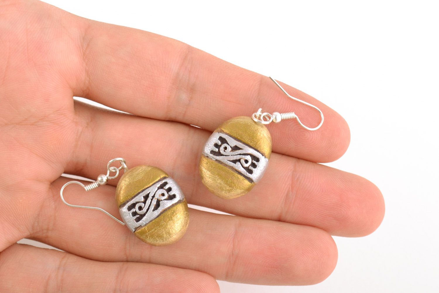 Unusual handmade ceramic dangling earrings of oval shape and golden color photo 2