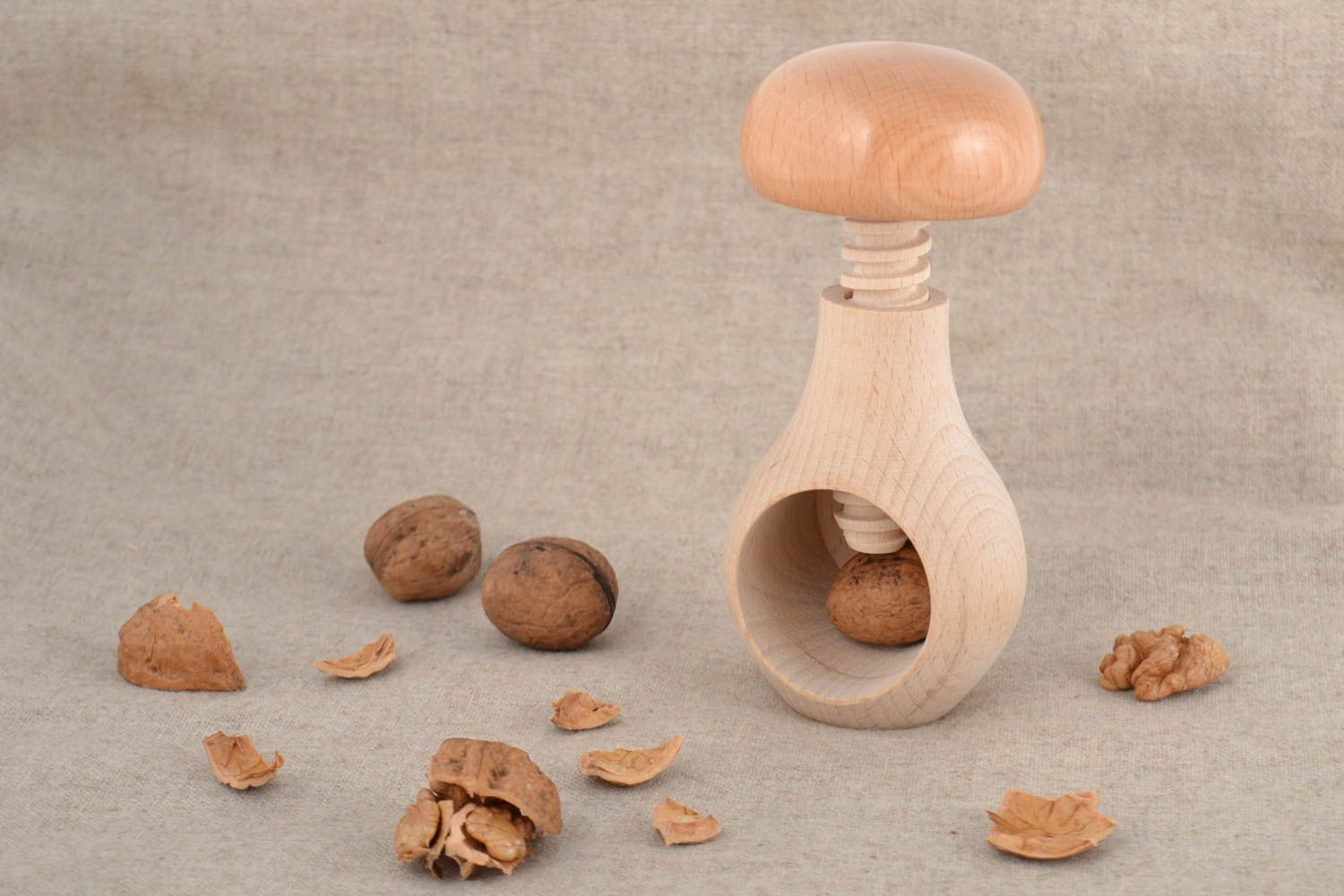 Handmade natural varnished light wooden nutcracker in the shape of mushroom photo 1