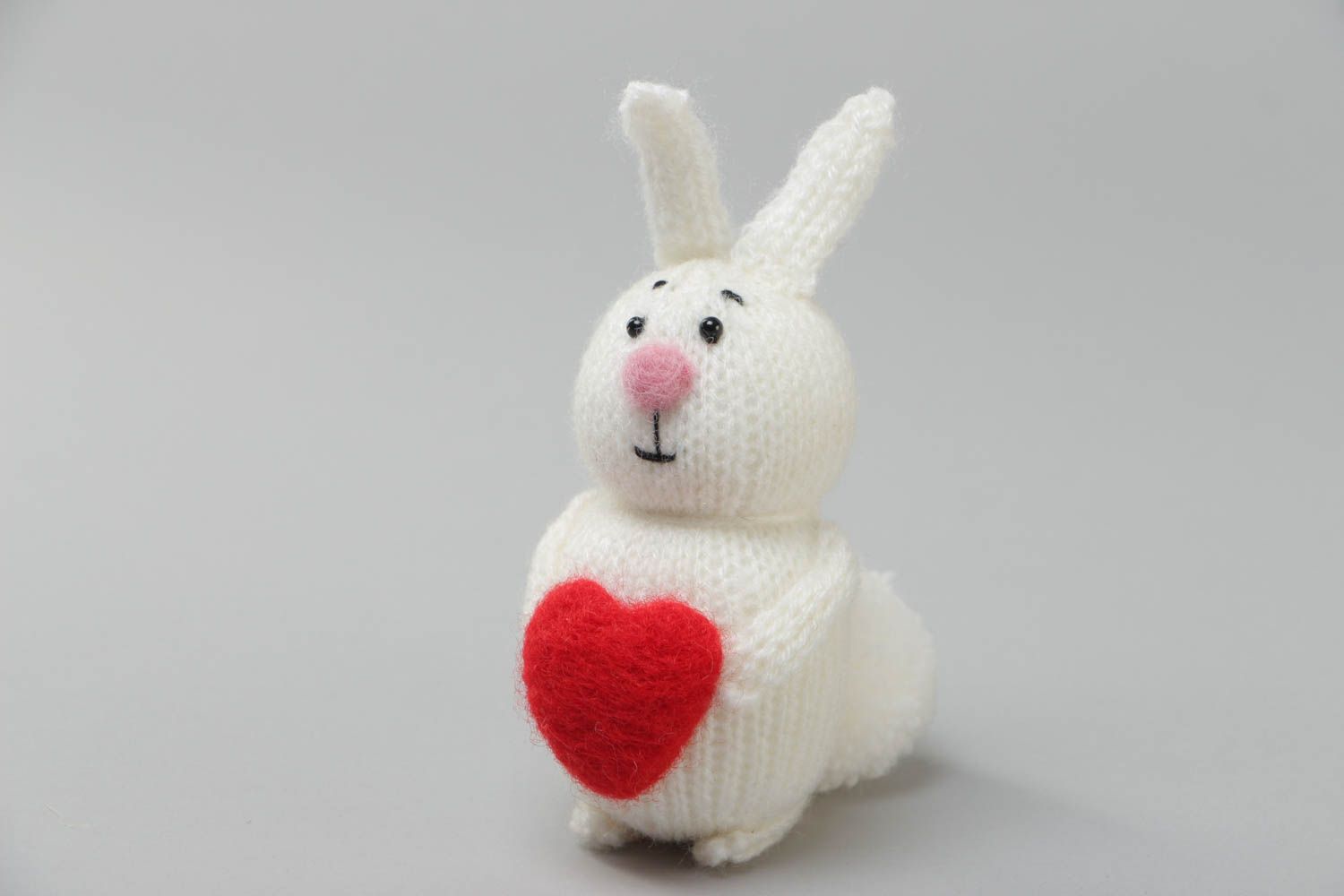 Handmade small soft toy knitted of acrylic threads white rabbit with red heart photo 2