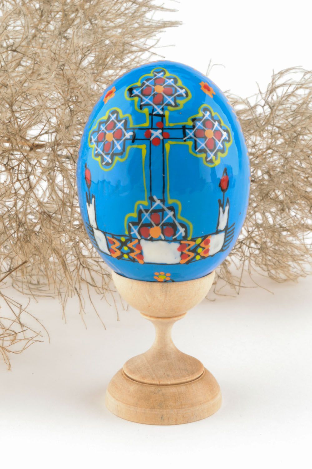 Wooden painted egg in blue color photo 1
