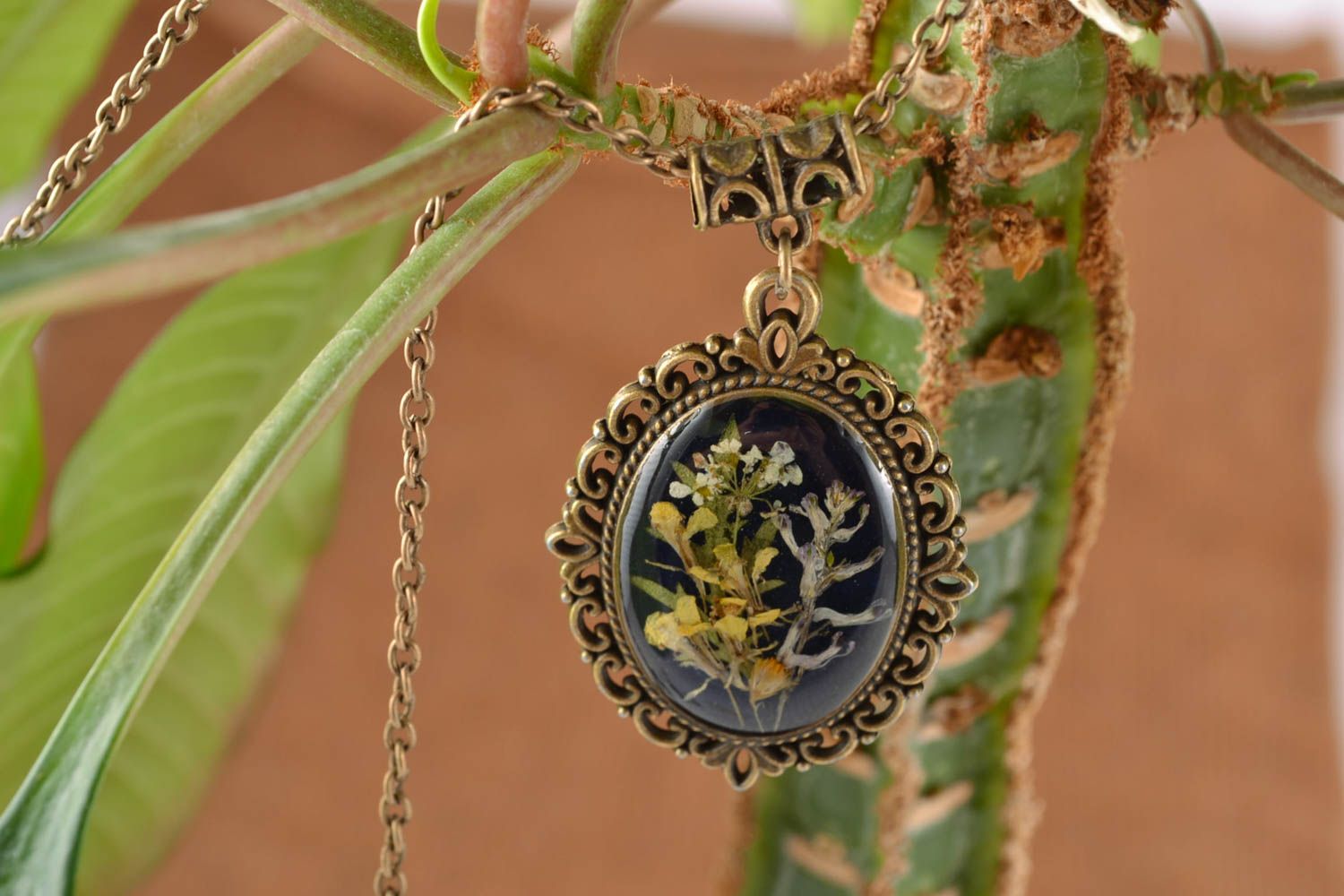 Flower in epoxy resin pendant on long chain photo 1