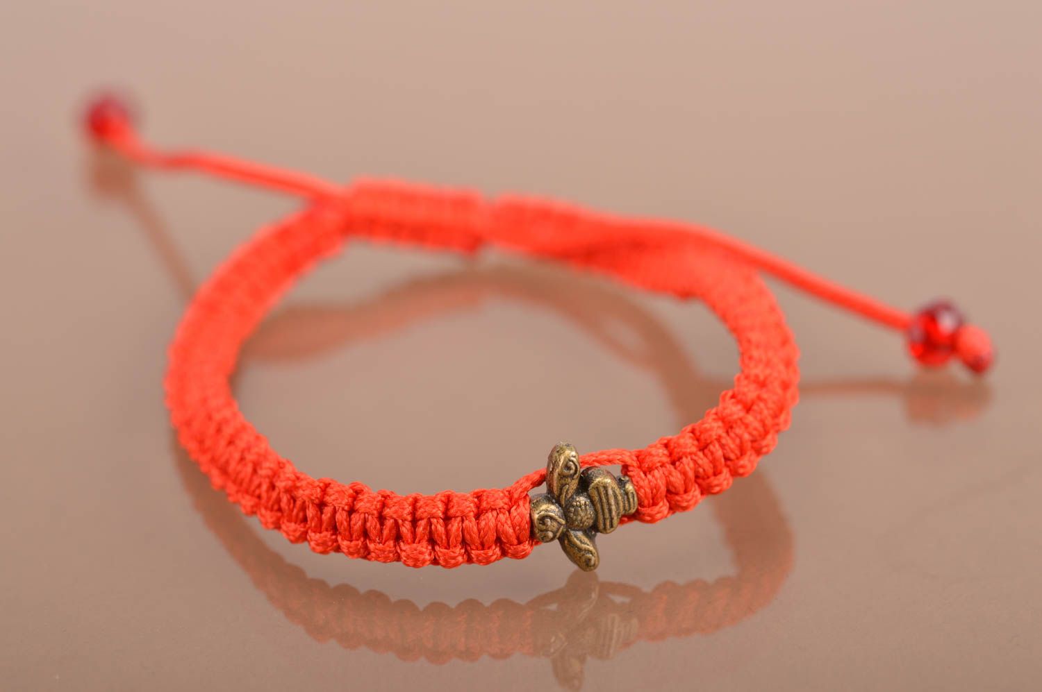 Rotes elegantes schönes handgemachtes Armband aus Fäden mit Einsatz aus Metall foto 2