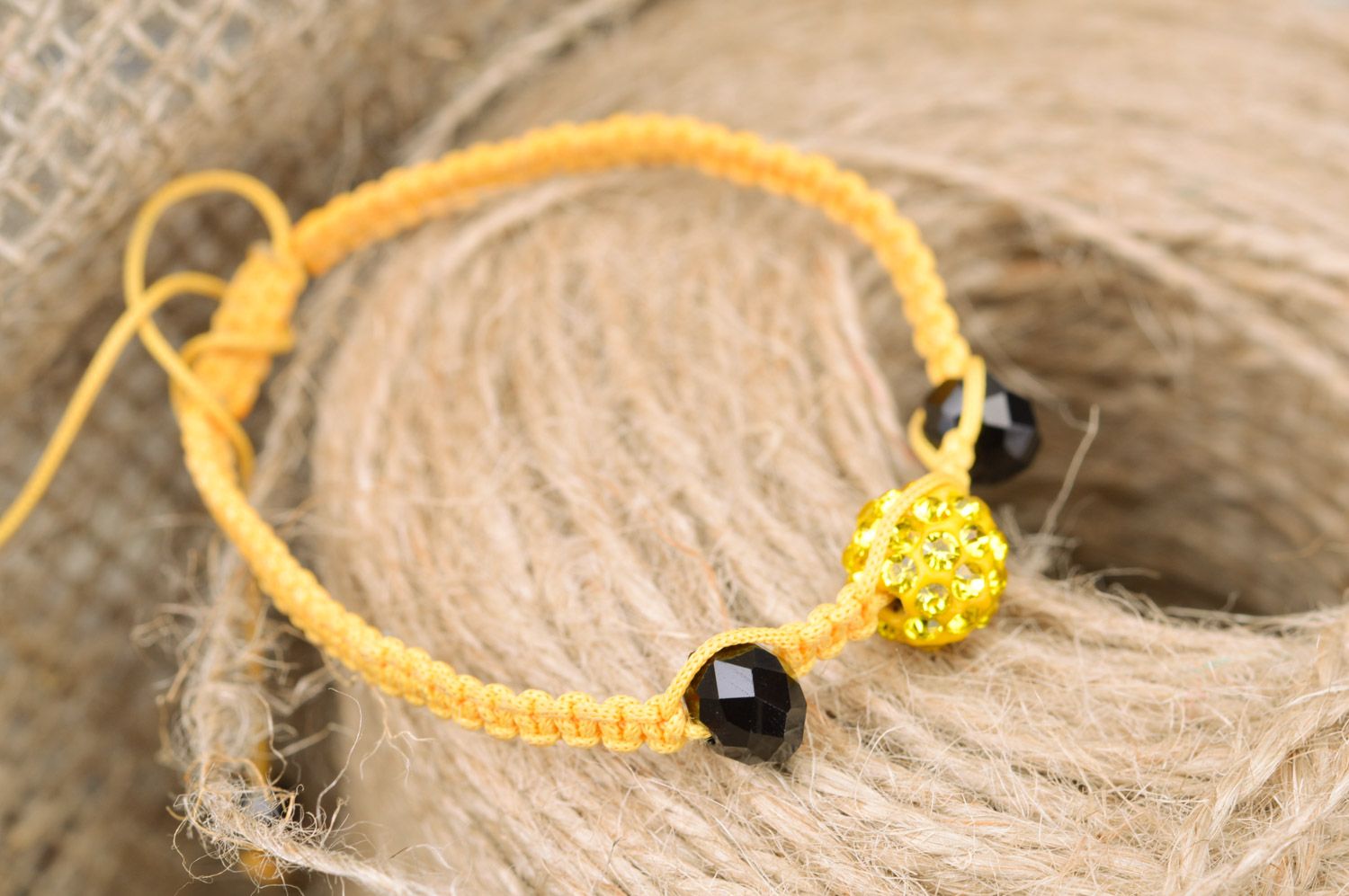 Stylish gentle handmade wrist bracelet woven of yellow threads and black beads photo 1