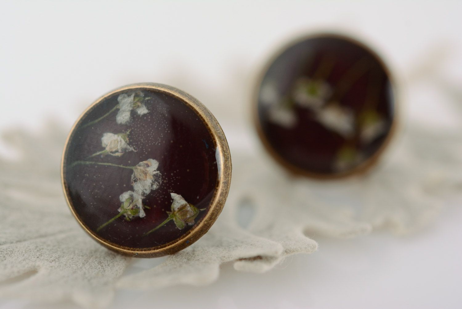 Small flat round dark homemade stud earrings with dried flowers in epoxy resin  photo 1