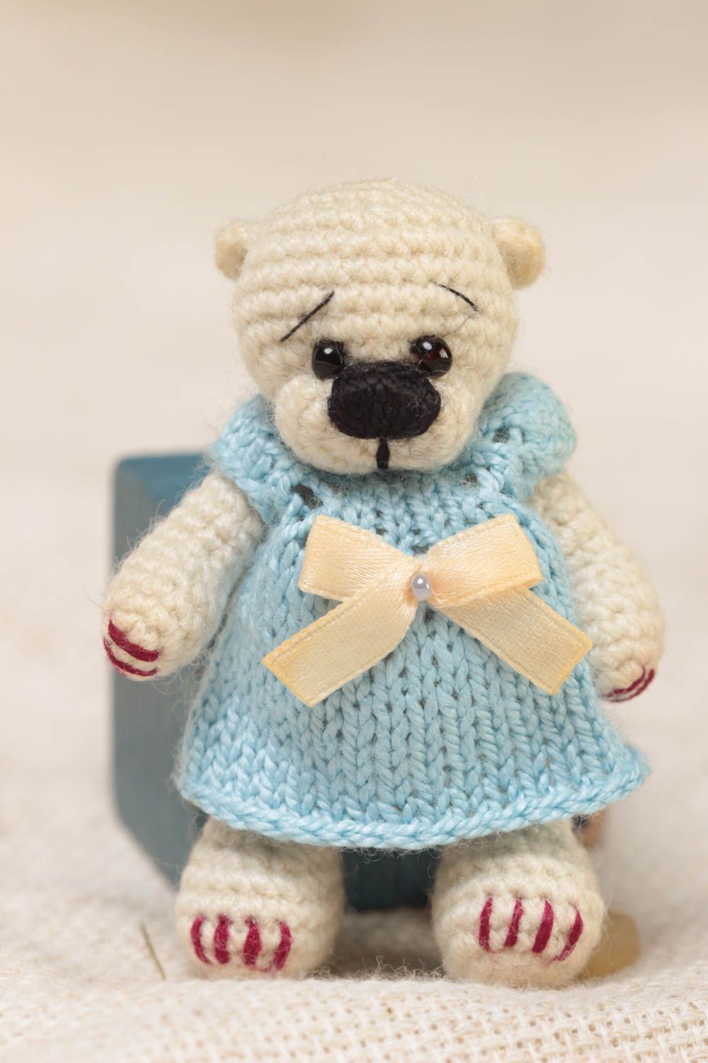 Handmade small crocheted soft toy beige bear girl in blue dress with bow photo 1