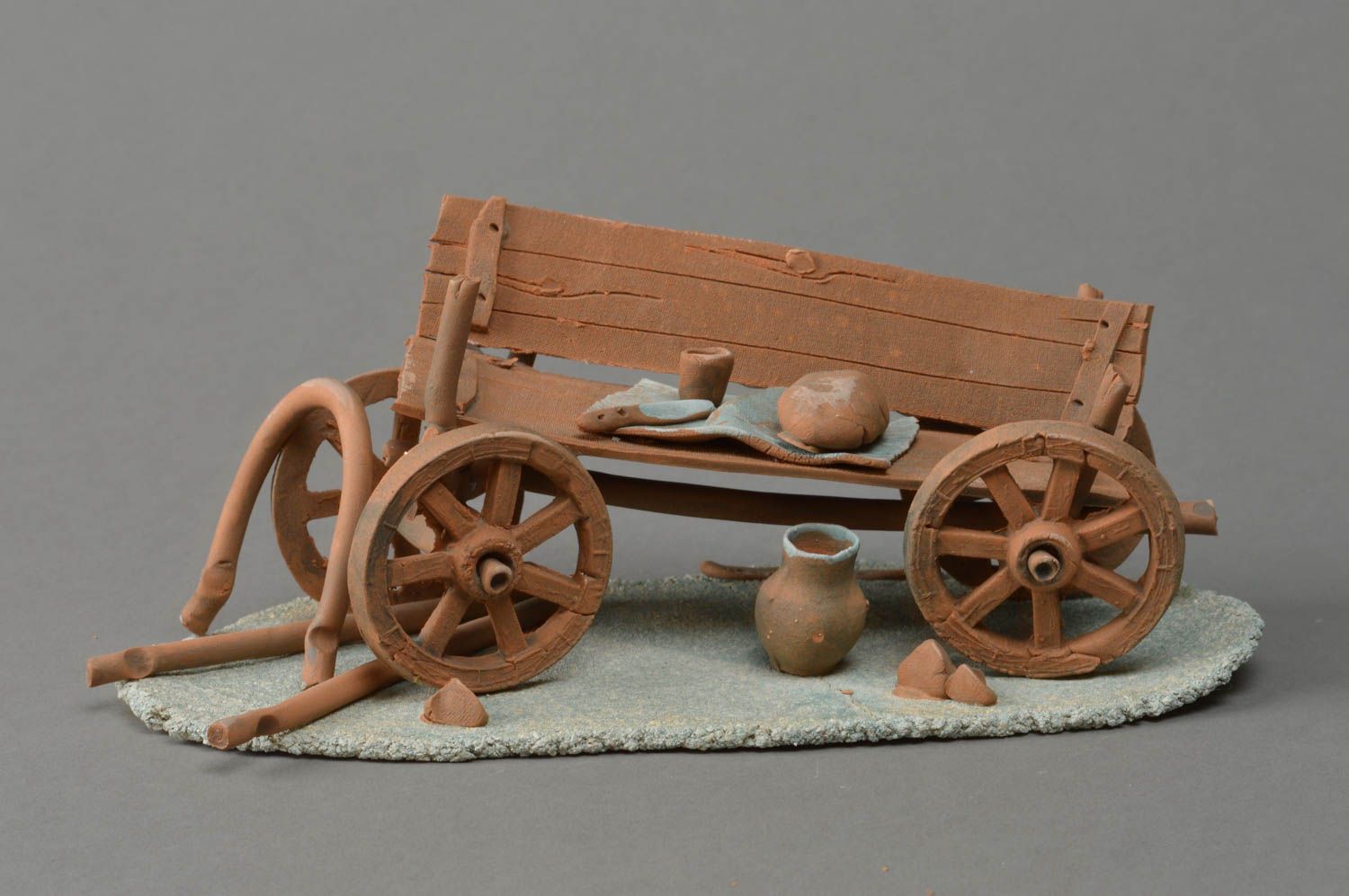 Handmade designer white red and chamotte clay figurine of cart table decoration photo 1