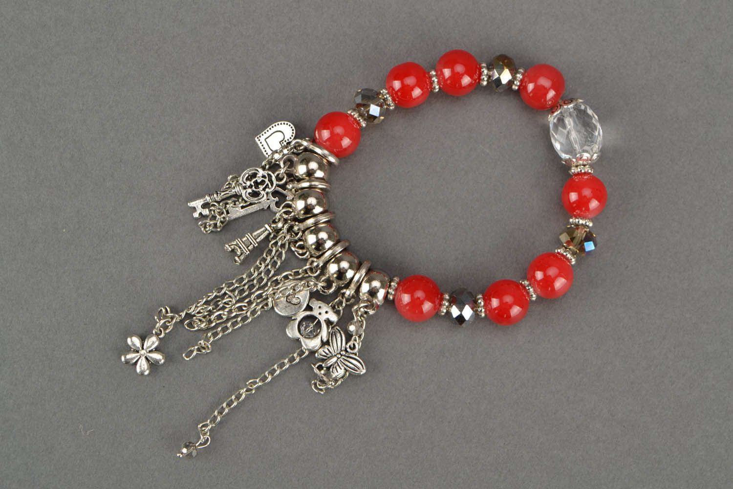 Red bracelet with charms photo 1