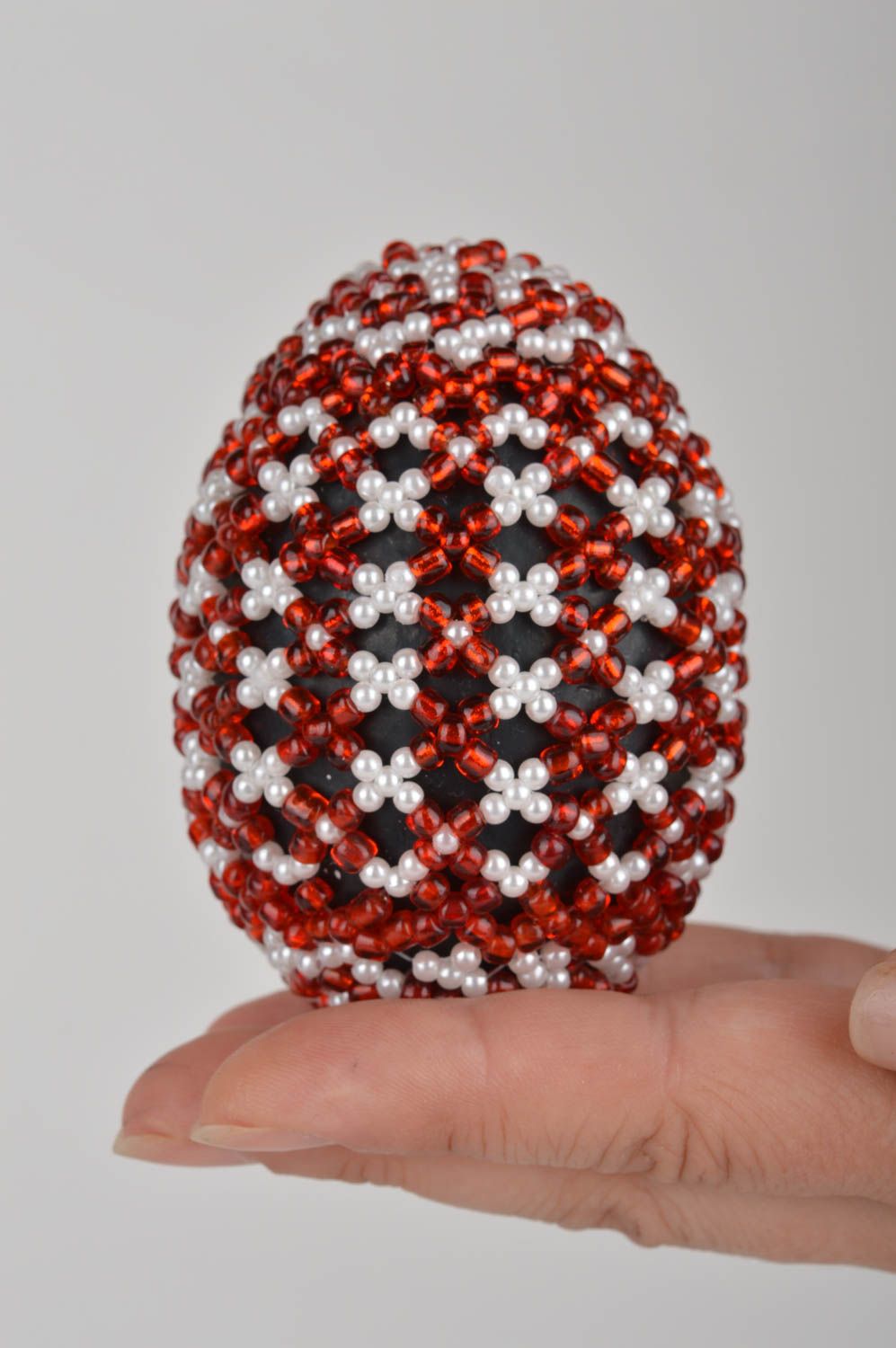 Red and white handmade papier mache egg woven over with beads on holder photo 5