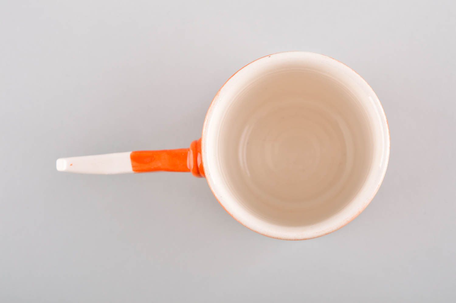 Art style porcelain drinking cup in orange and white color. Stick shape handle. photo 4