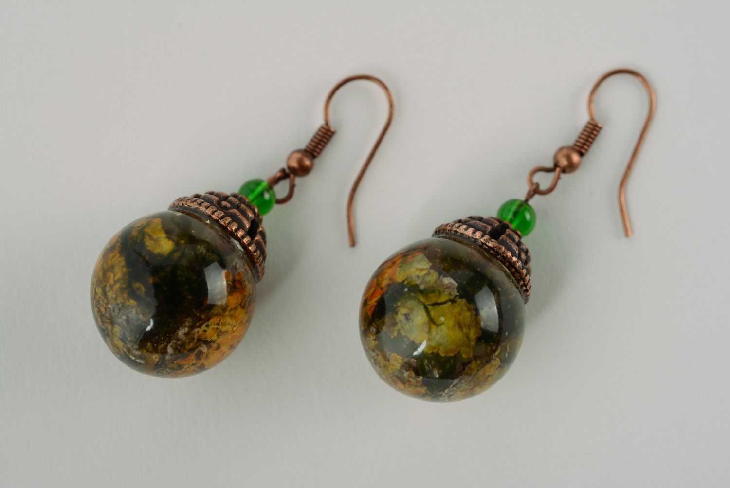 Handmade ball earrings with lichen plant coated with epoxy resin photo 1