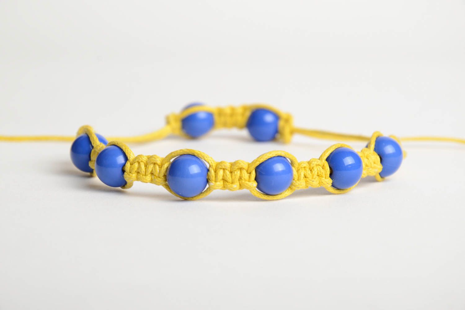 Handmade friendship bracelet woven of yellow cord and blue beads for children photo 5