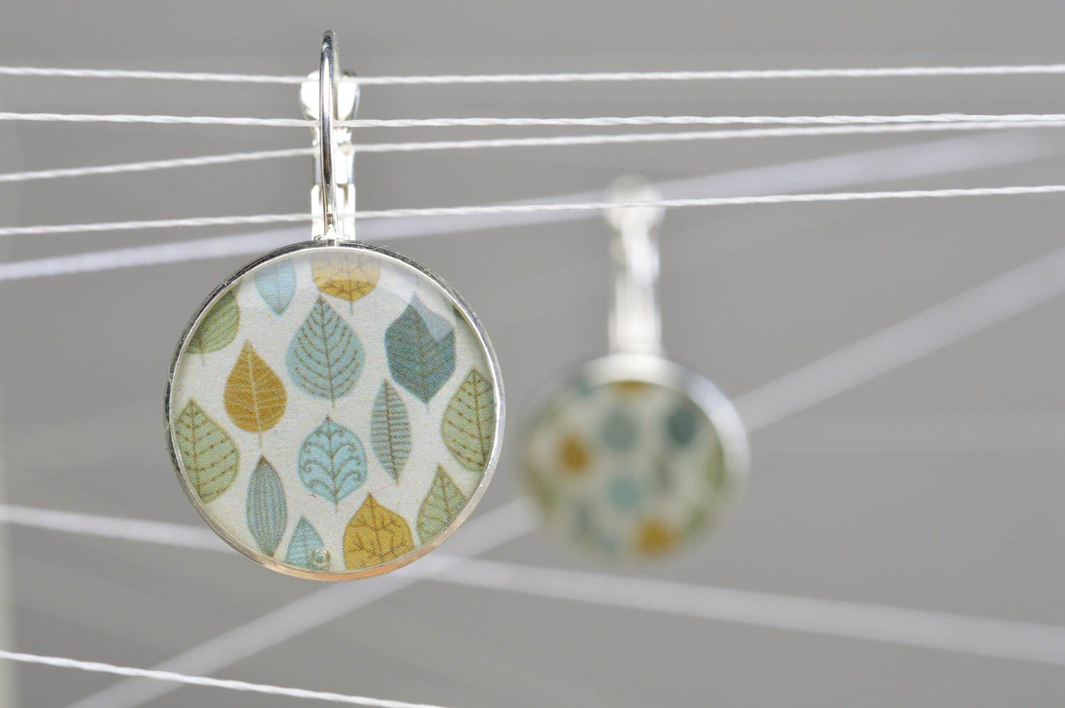 Handmade designer light round decoupage dangling earrings in epoxy resin Leaves photo 1