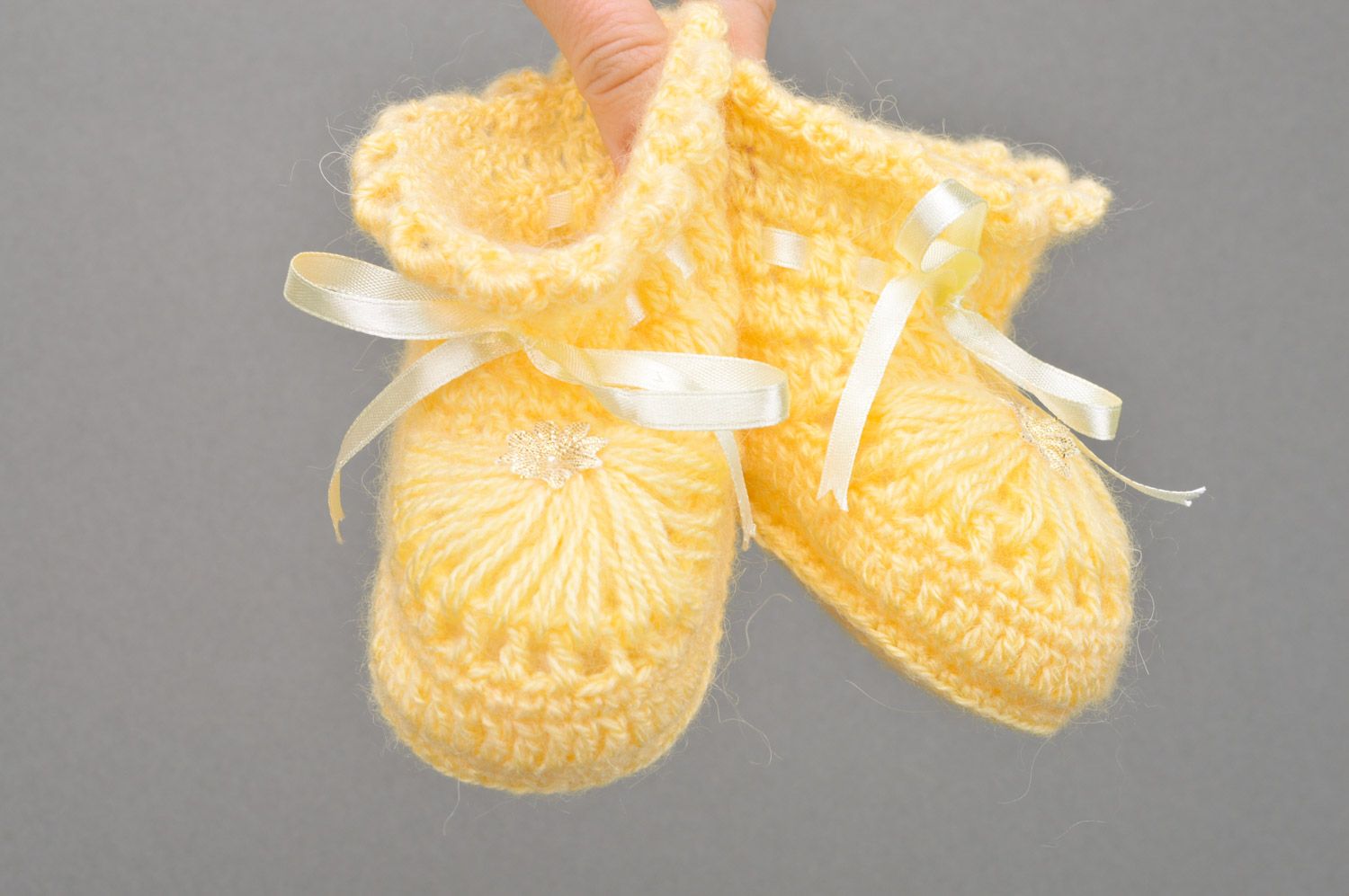 Handmade crocheted yellow baby booties made of acrylic with ribbon for girls photo 3