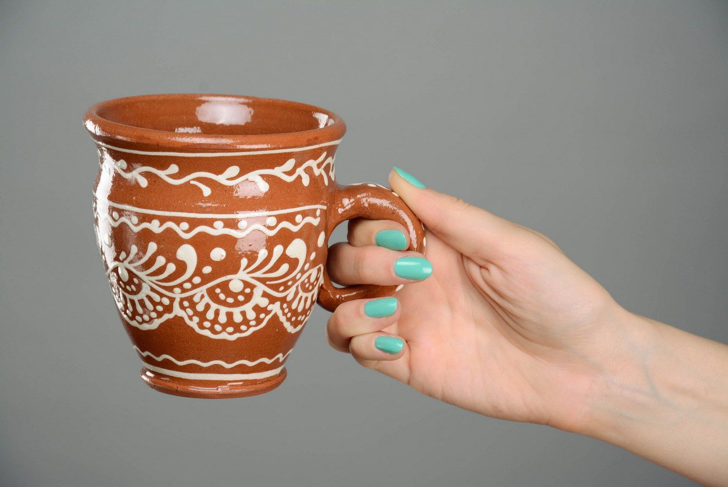 Glazed clay tea cup in terracotta color with eco pattern in white color photo 5