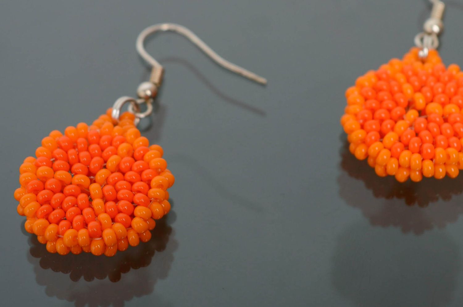 Round beaded earrings of orange color photo 3