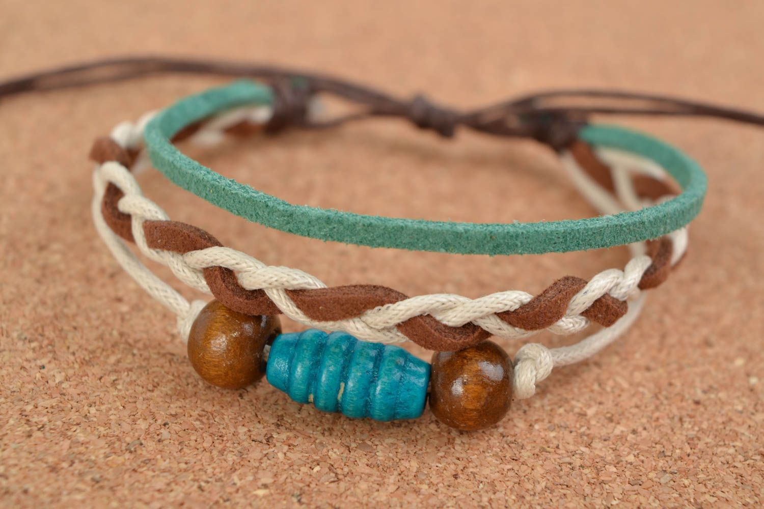 Unusual stylish handmade woven suede bracelet with wooden beads photo 1