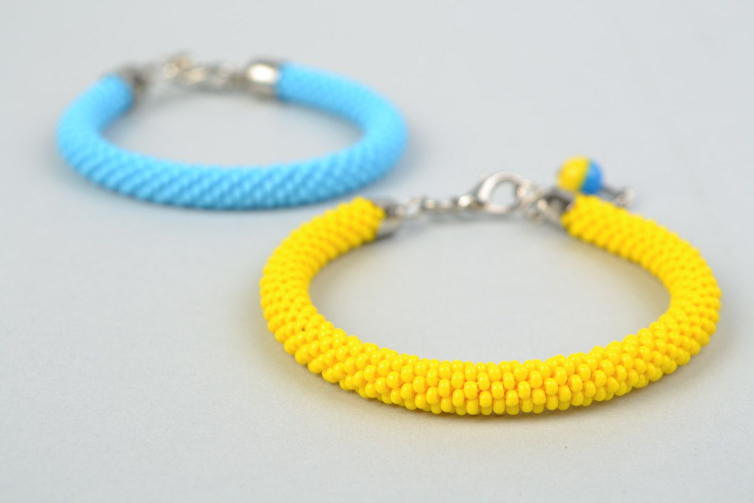 Set of 2 handmade beaded cord wrist bracelets of yellow and blue colors  photo 3