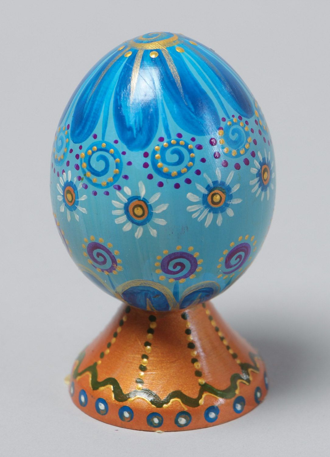 Handmade decorative blue painted wooden egg on stand for Easter decoration photo 2