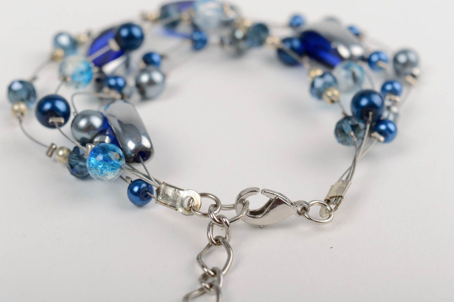 Handmade designer wrist bracelet with dark blue ceramic pearls and crystal beads photo 3