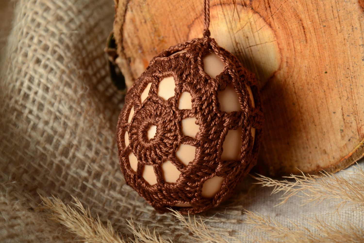 Handmade brown Easter egg woven over with cotton threads photo 1