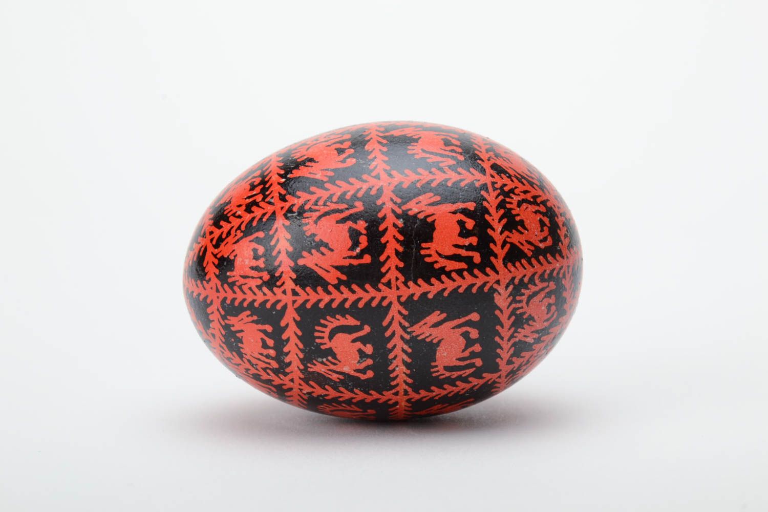Black and red homemade painted Easter egg decorated using waxing technique photo 3