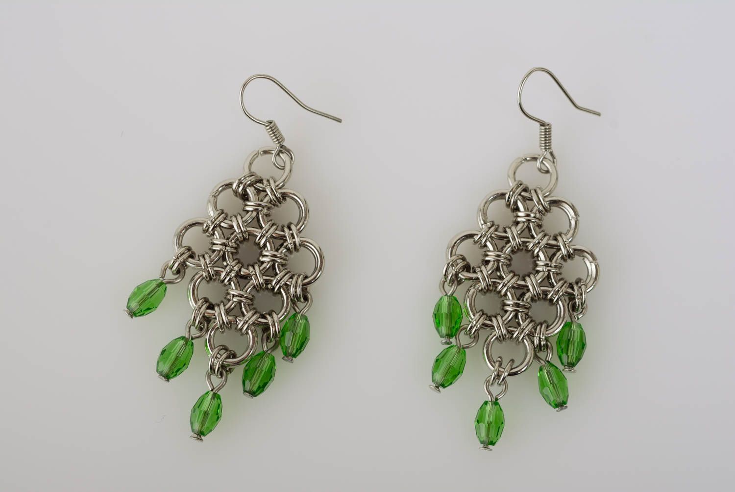 Originelle grüne Ohrringe aus Metall mit Glasperlen künstlerische Handarbeit foto 1