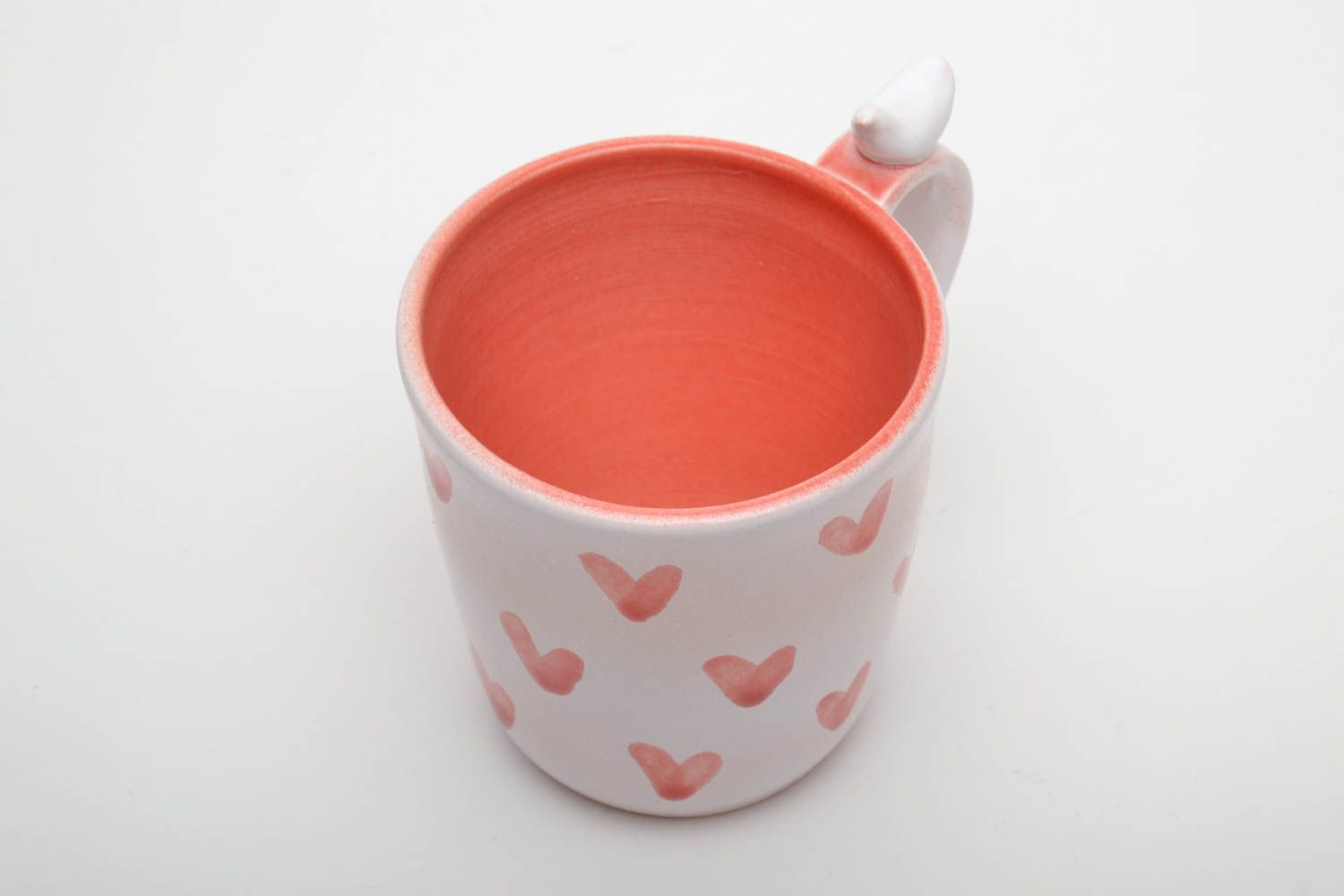 Ceramic handmade coffee cup with handle in white and orange color with hearts' pattern photo 4