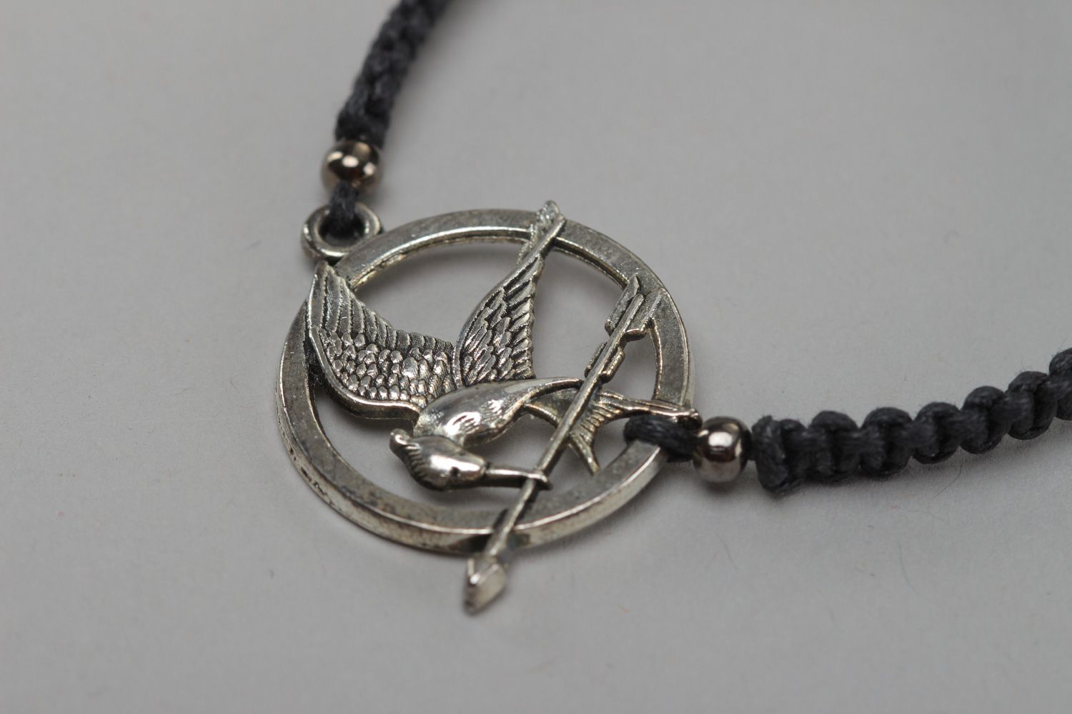 Handmade black friendship wrist bracelet woven of cord with metal charm Mokingjay photo 3