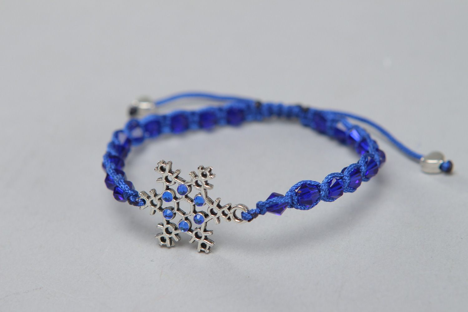 Handmade friendship bracelet woven of cord with crystal beads and metal snowflake photo 1