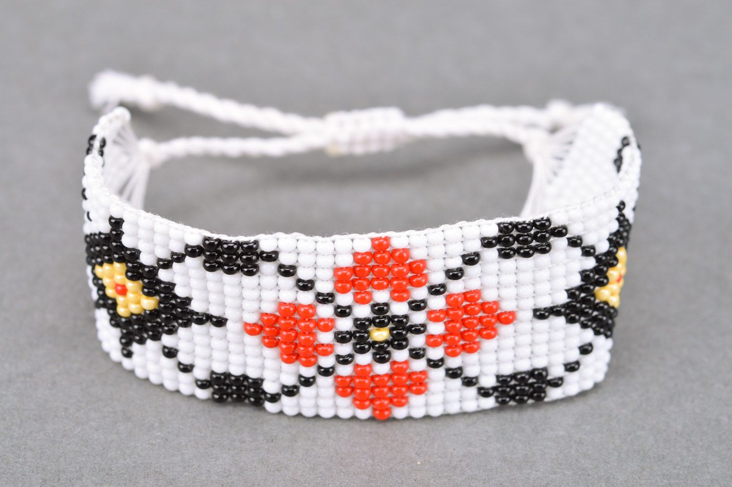 Handmade wide women's woven bead bracelet of white color with ornament photo 2