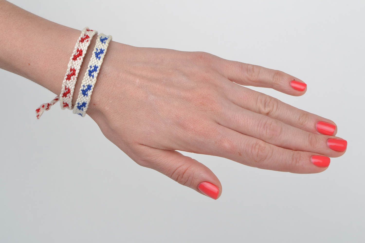 Set of 2 handmade white friendship wrist bracelets with red and blue inserts photo 2