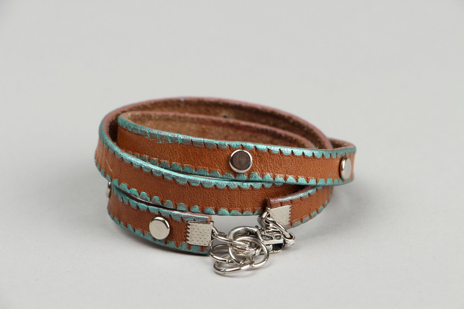 Leather bracelet on the hand with rivets photo 4